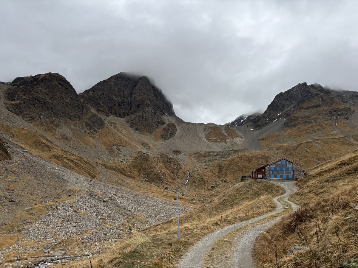 Chamonna Tuoi beneath rocky mountains
