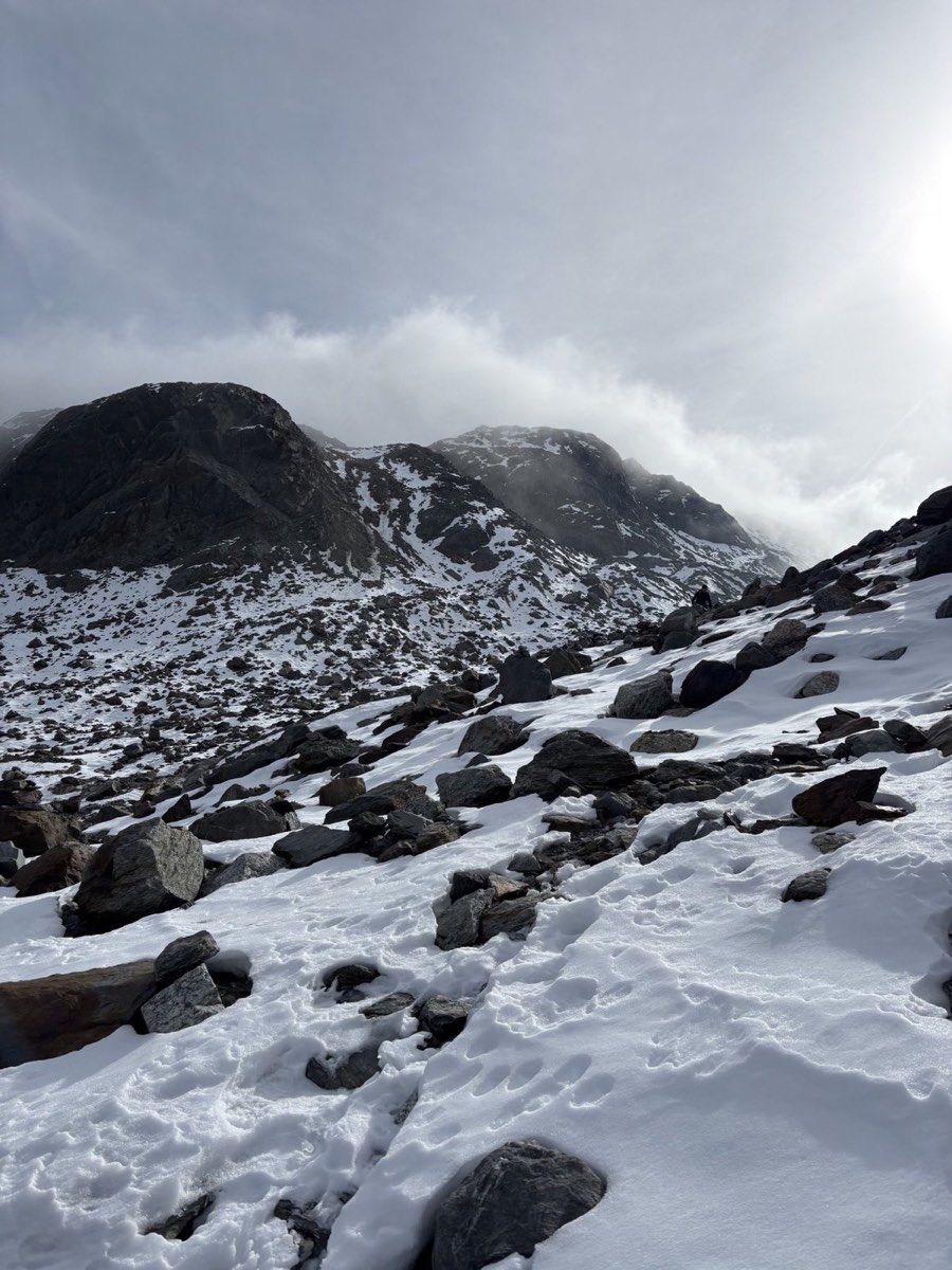 Snow covering blocky alpine terrain on the north side of Fuorcla Sura da Lavaz