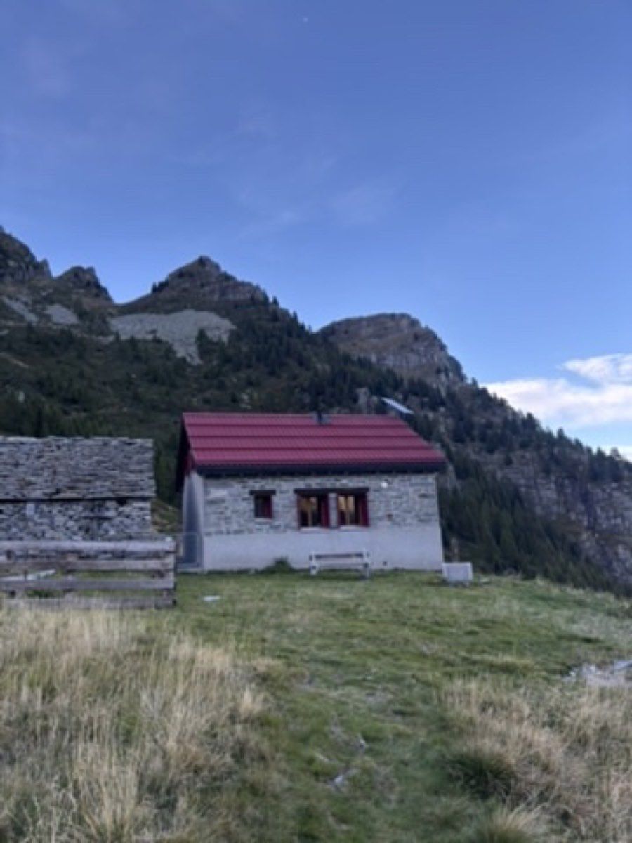 The unstaffed stone Capanna Lèis beneath the mountains of Valle di Moleno