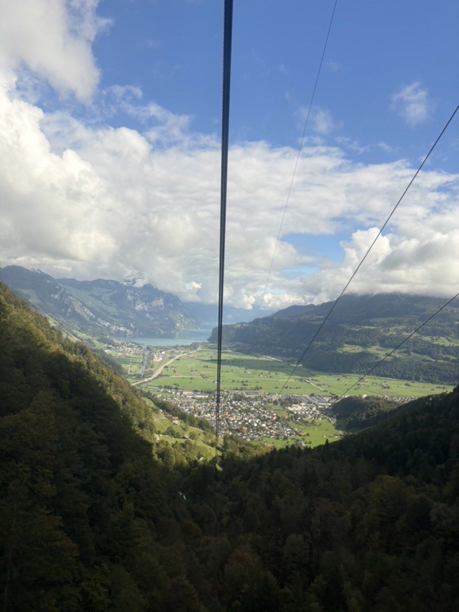 View down a gondola cable towards Näfels and the valley