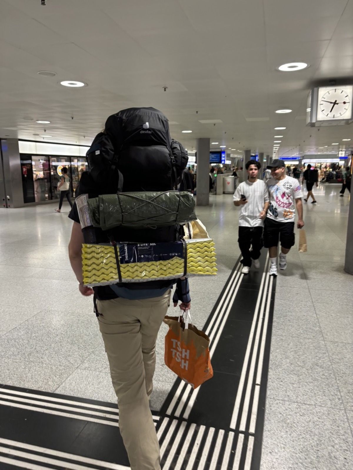 A fully loaded hiking backpack moving through Zurich main station